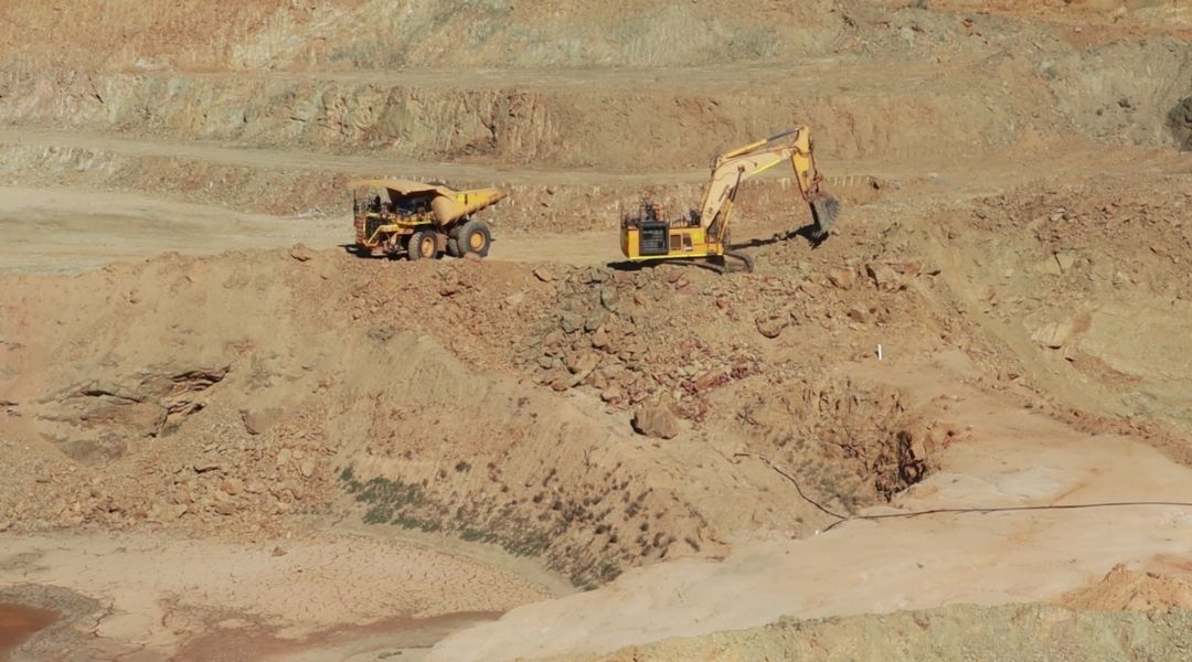 drillers in an open pit mine